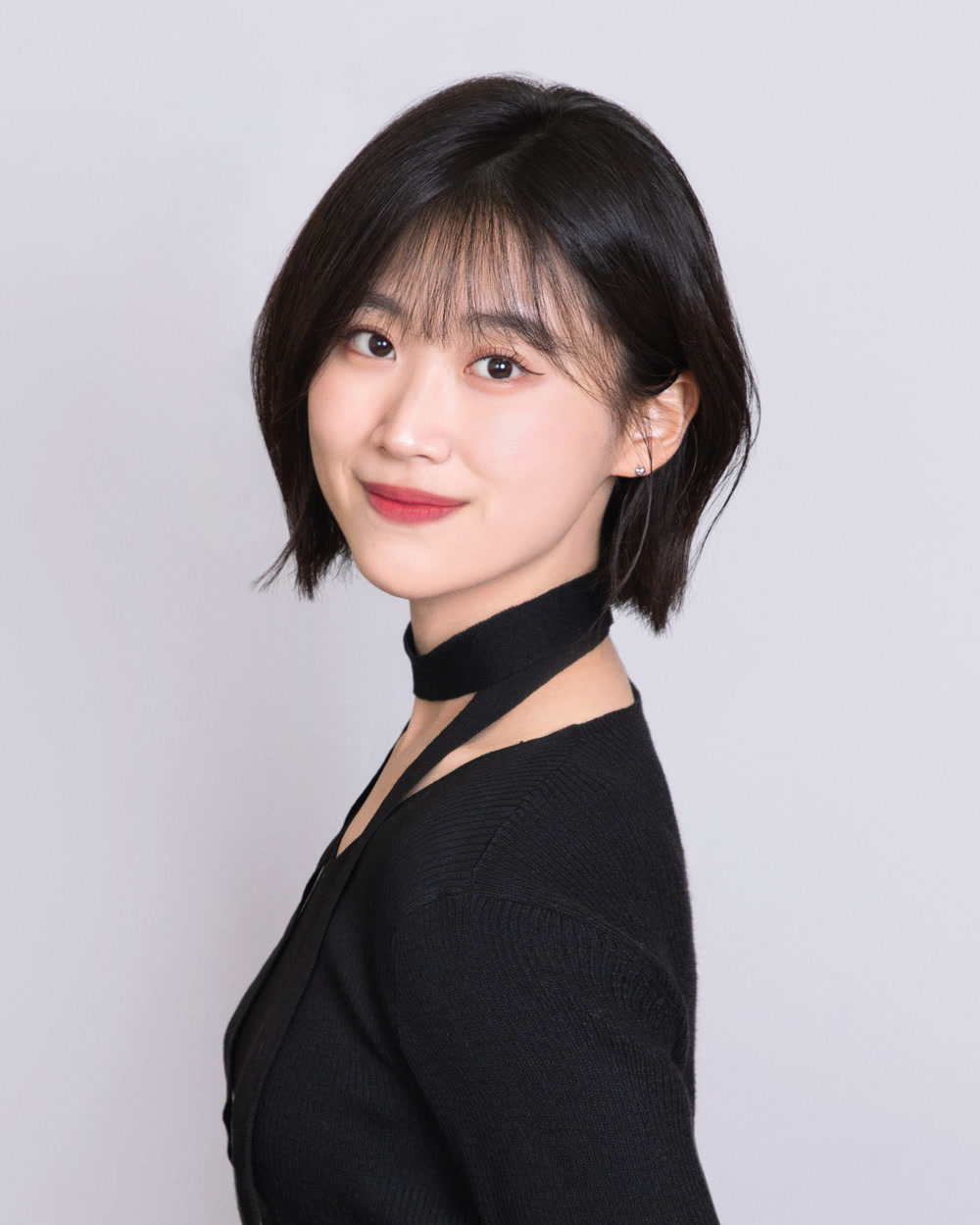 Selin Choi with short hair, wearing a black top